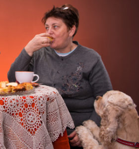 Mother and daughter having tea with apple pie on an orange  background